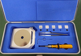 an open case showing Pulstec’s collimator and two collimation tools